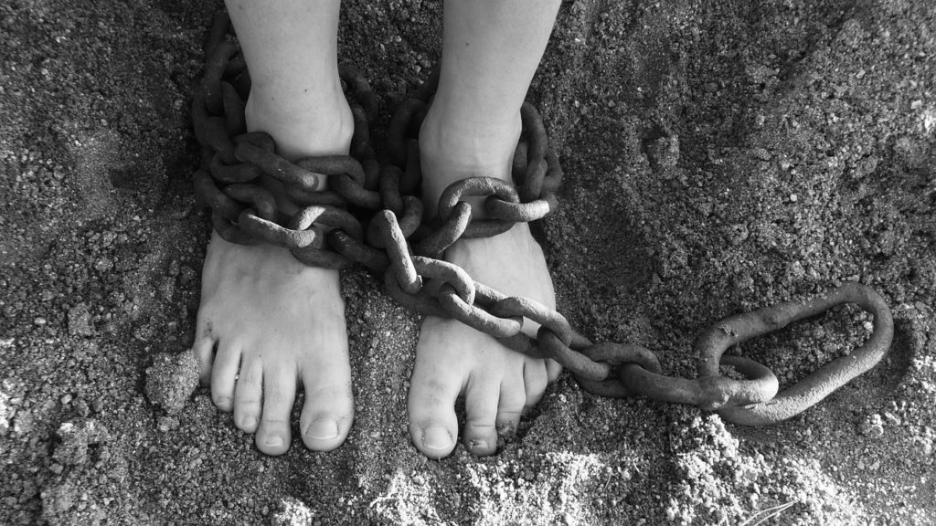 chains around bare feet in dirt.jpg