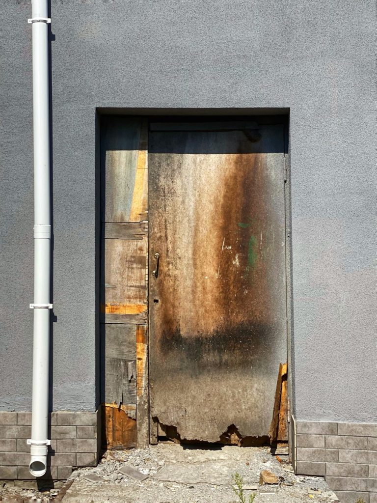 white metal pipe on blue concrete wall.jpg